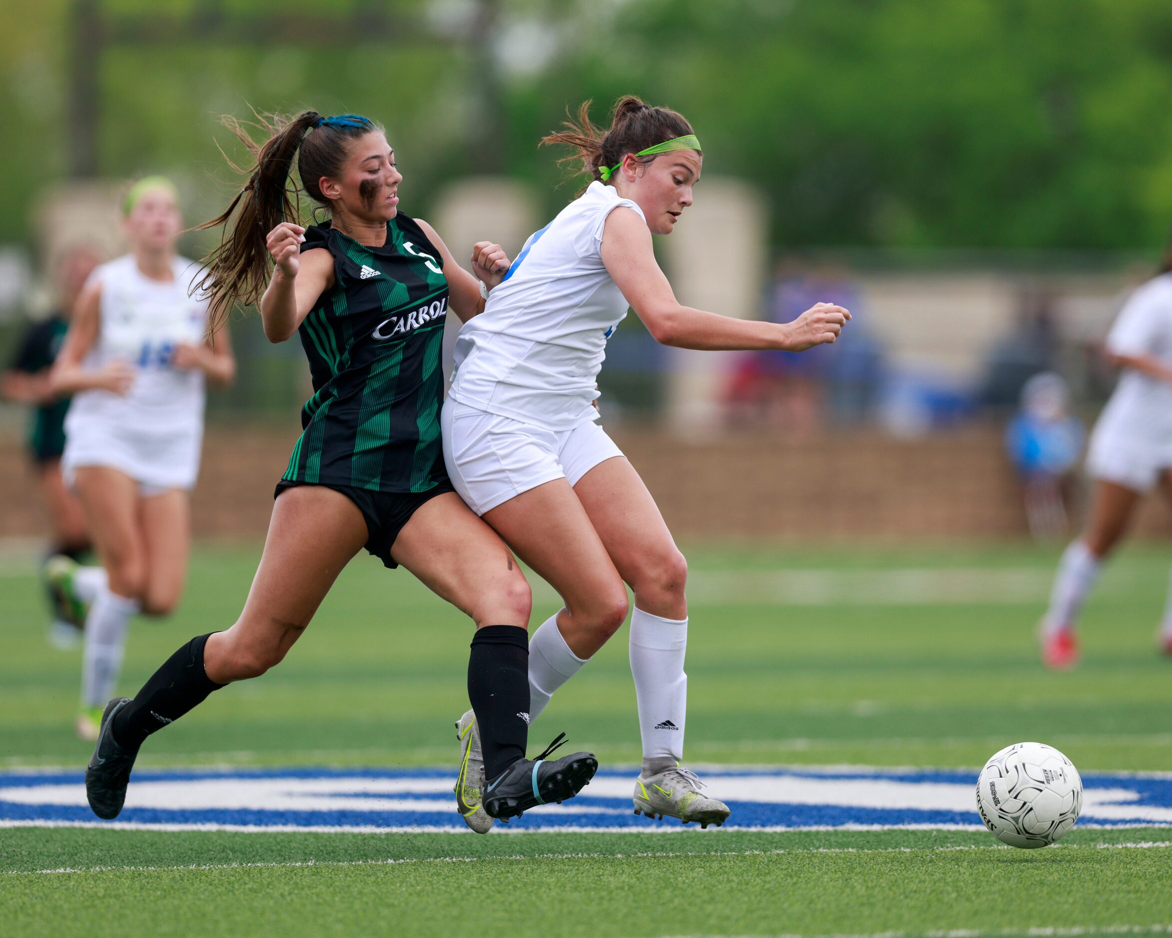 Southlake Carroll forward Madison Khan (5) and Austin Westlake defender Alex Biles (23)...