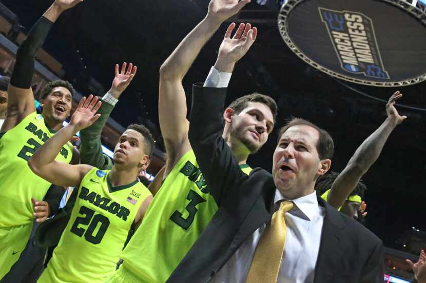 Baylor coach Scott Drew celebrates with guards Ishmail Wainright (24), Manu Lecomte (20) and...