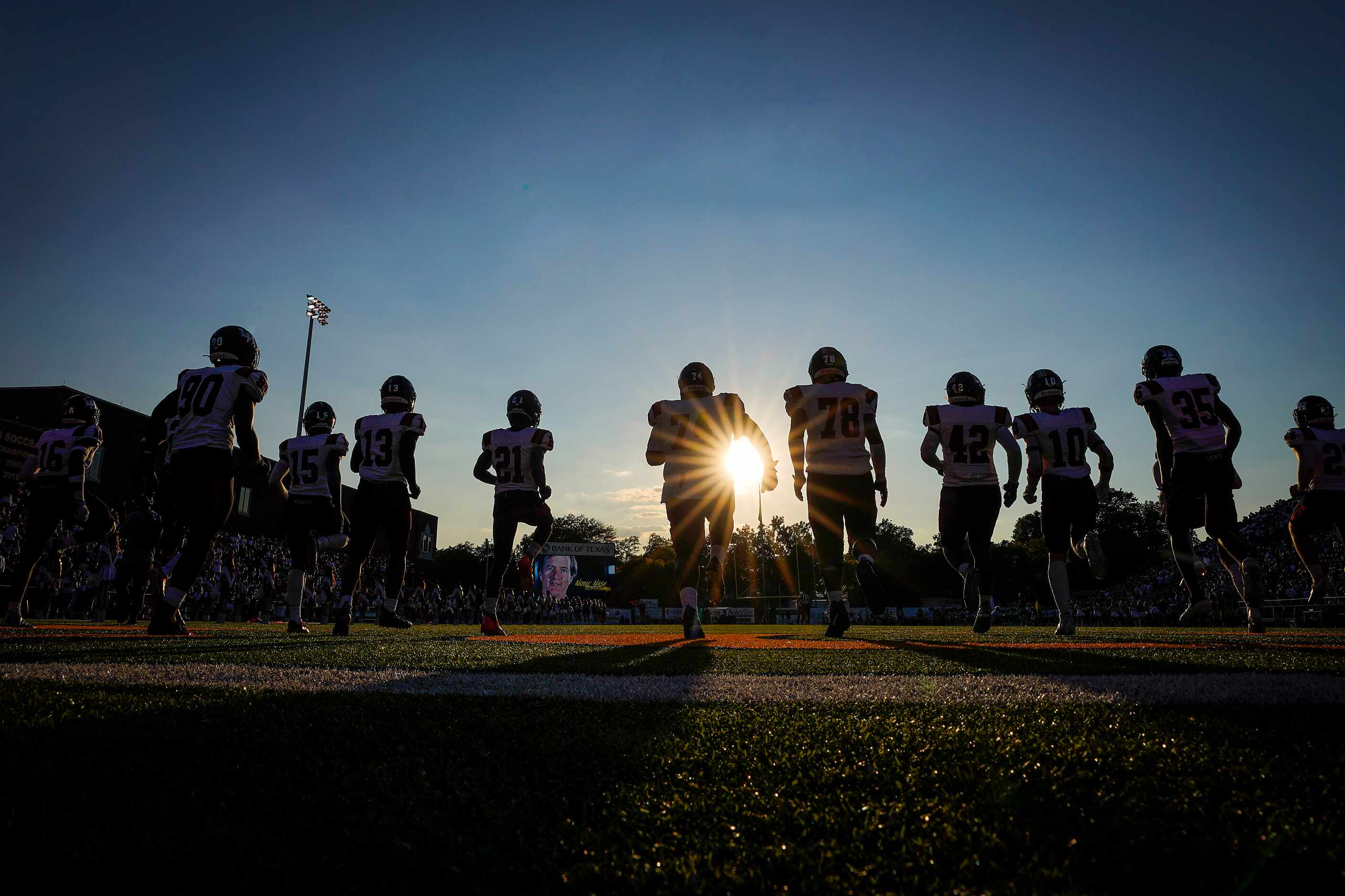 Lake Highlands players warm up before a high school football game against Highland Park on...