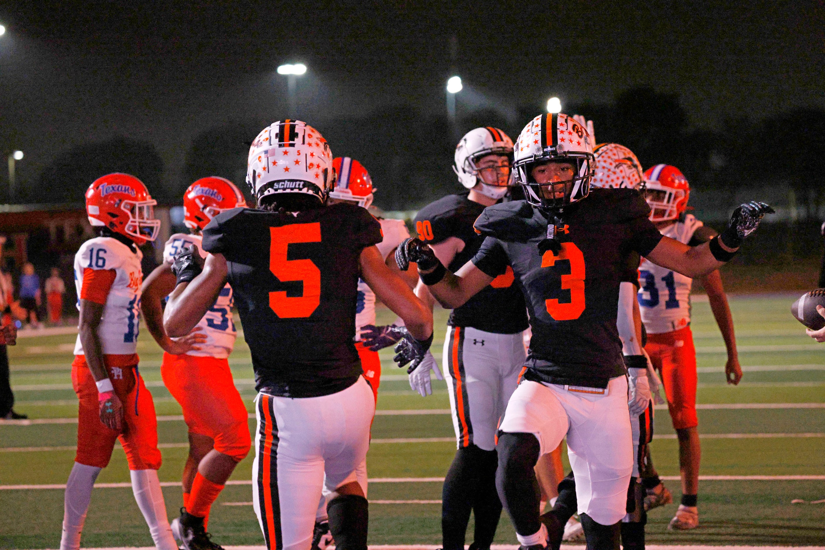 Haltom's Vudrico Roberson (5) celebrates with his teammate Haltom's Keenan Jackson (3) after...