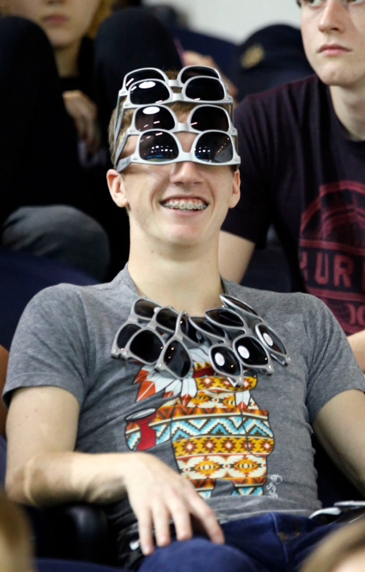 Wakeland student Hunter Lightfoot, 17, a senior, sports four pairs of glasses while watching...