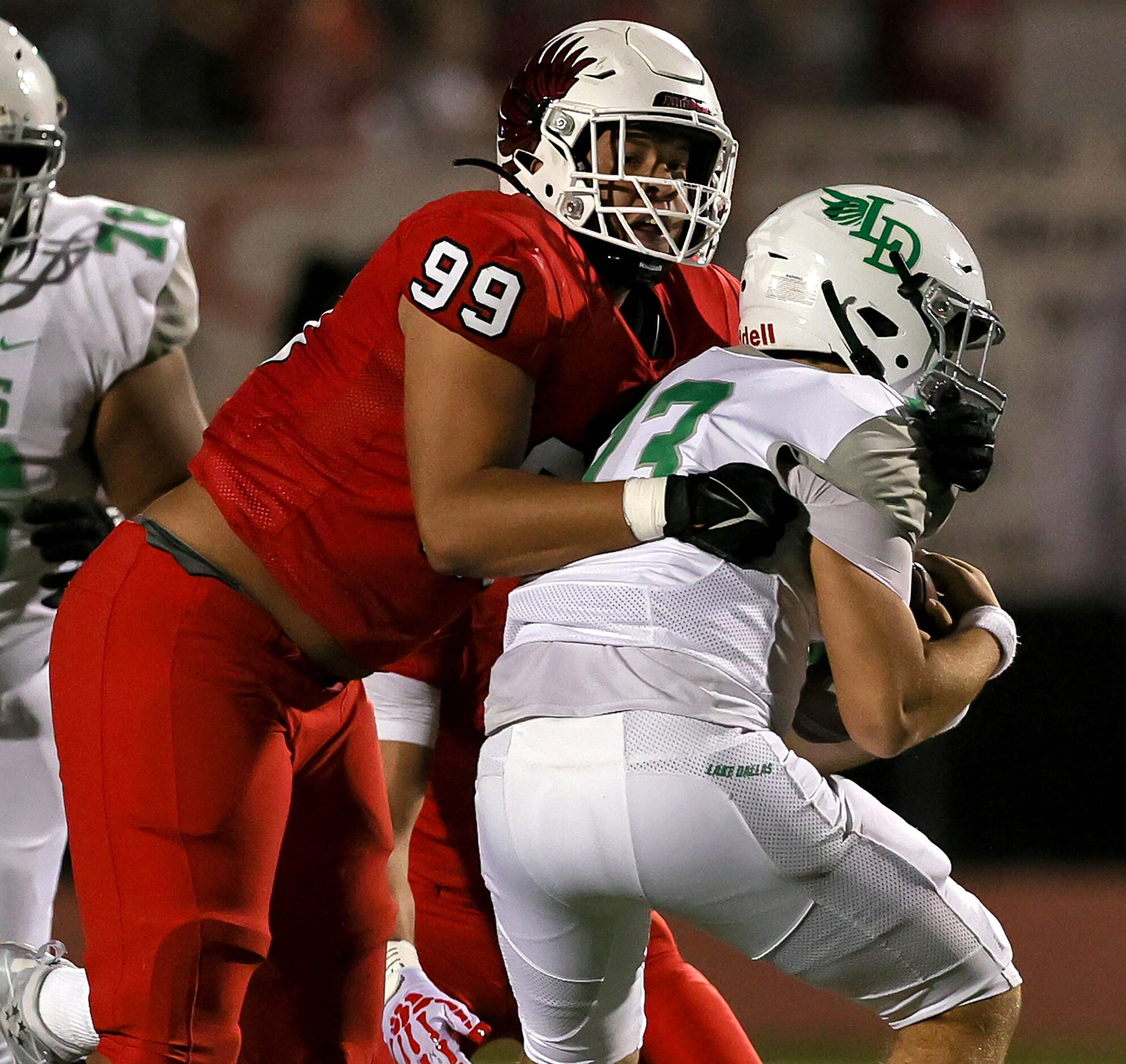 Argyle defensive lineman Michael Madrie (99) gets a sack on Lake Dallas quarterback Cade...