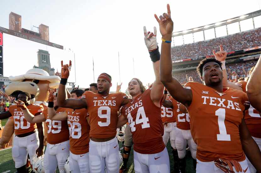 Texas wide receiver Collin Johnson (9) and defensive lineman Breckyn Hager (44) celebrate...