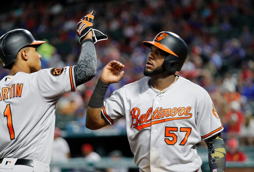 Baltimore Orioles' Richie Martin (1) and Hanser Alberto (57) celebrate after Alberto scored...