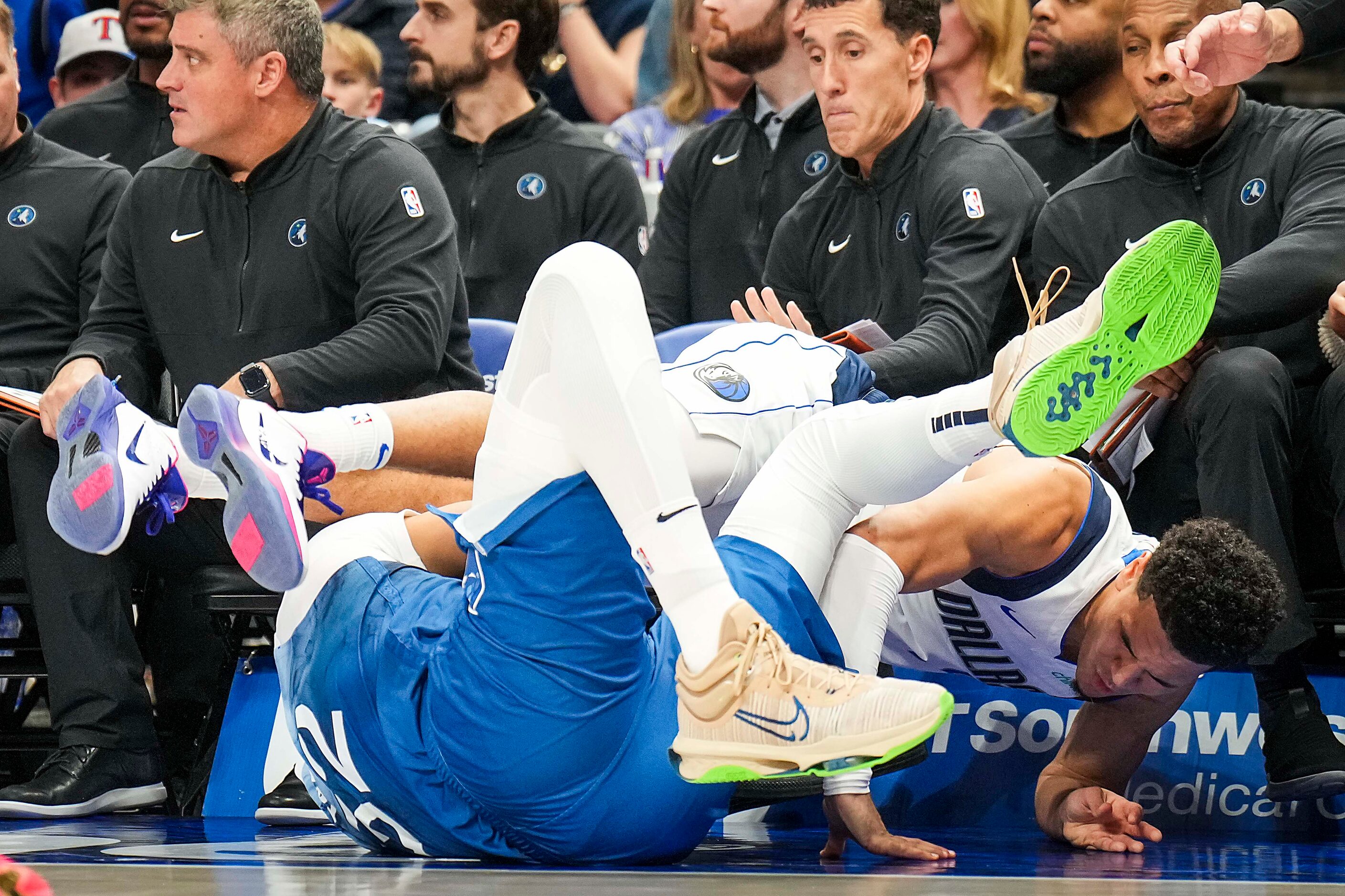 Dallas Mavericks guard Josh Green (8) tumbles out of bounds as he is fouled by Minnesota...