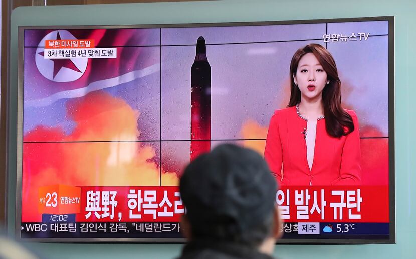 A man watches a TV news program reporting about North Korea's missile launch at the Seoul...