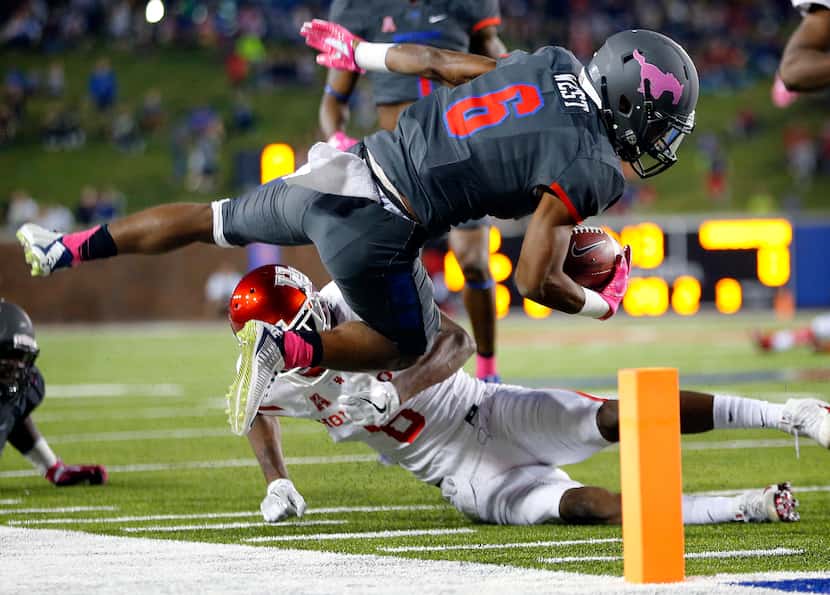 Southern Methodist Mustangs running back Braeden West (6) is flipped by Houston Cougars...