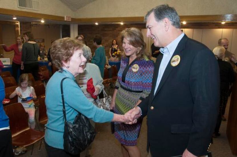 Martha Ribelin (left) greets Dallas Mayor Mike Rawlings (right) and city council member...