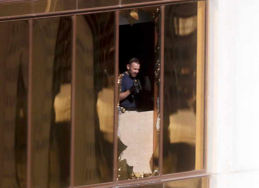 An investigator works in the room at the Mandalay Bay Resort and Casino where a gunman...