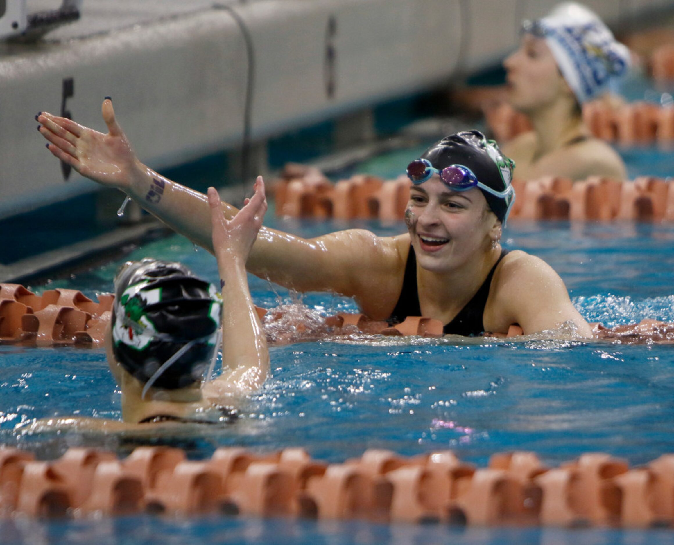 Southlake Carroll's Riley Francis sports a Texas-sized smile as she congratulates teammate...