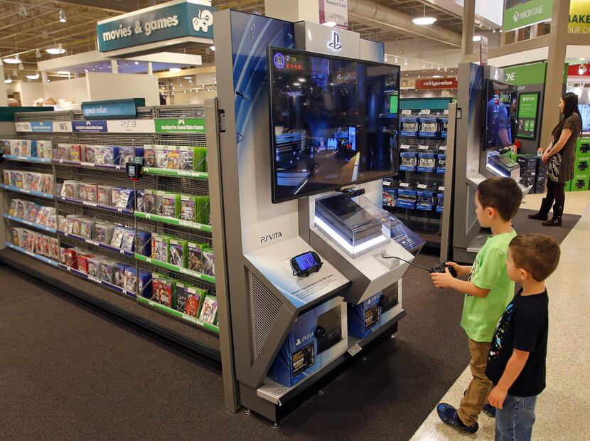 Children entertain themselves playing video games at the Nebraska Furniture Mart in The...