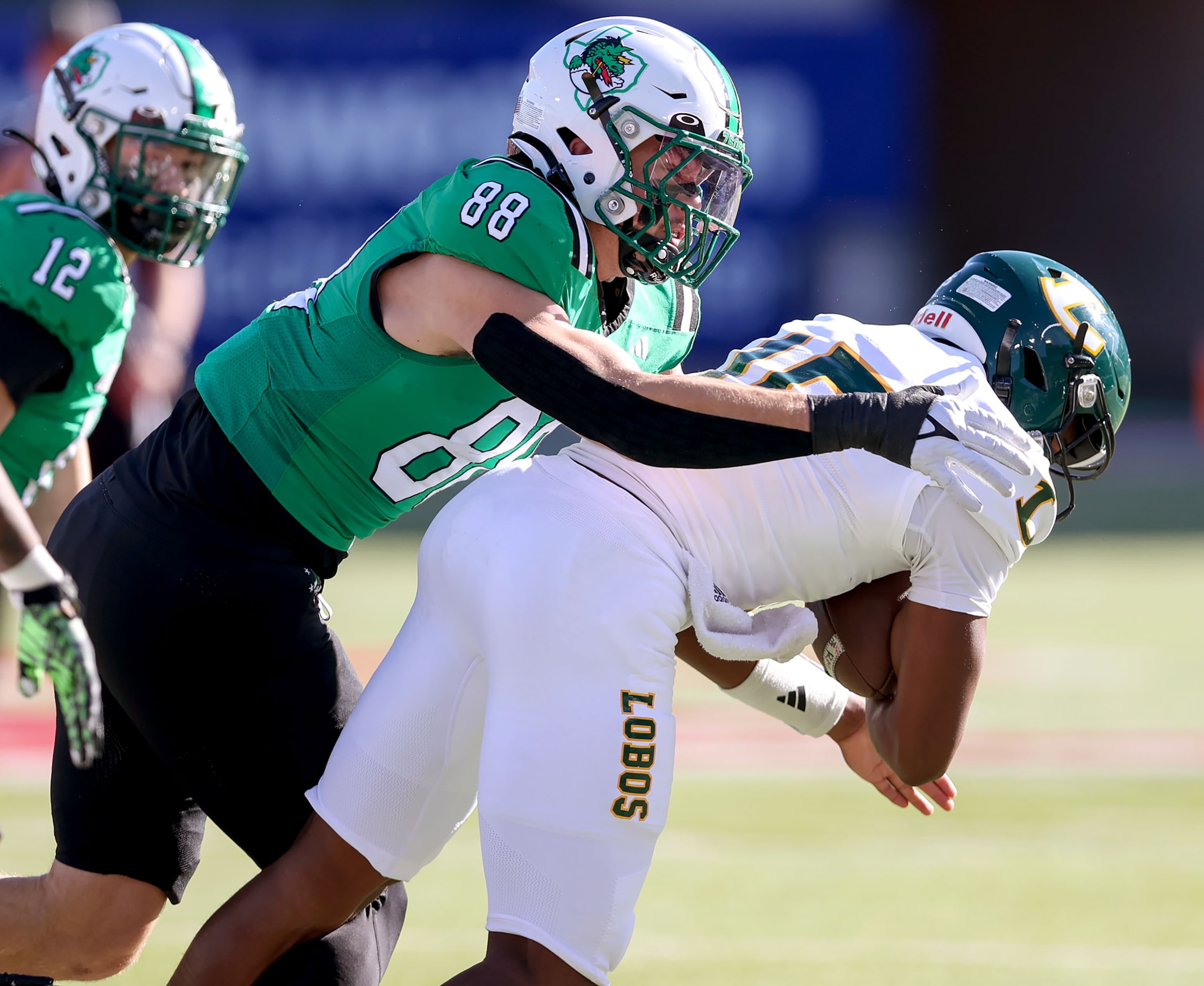 Southlake Carroll defensive end Jack Van Dorselaer (88) makes a stop on Longview quarterback...