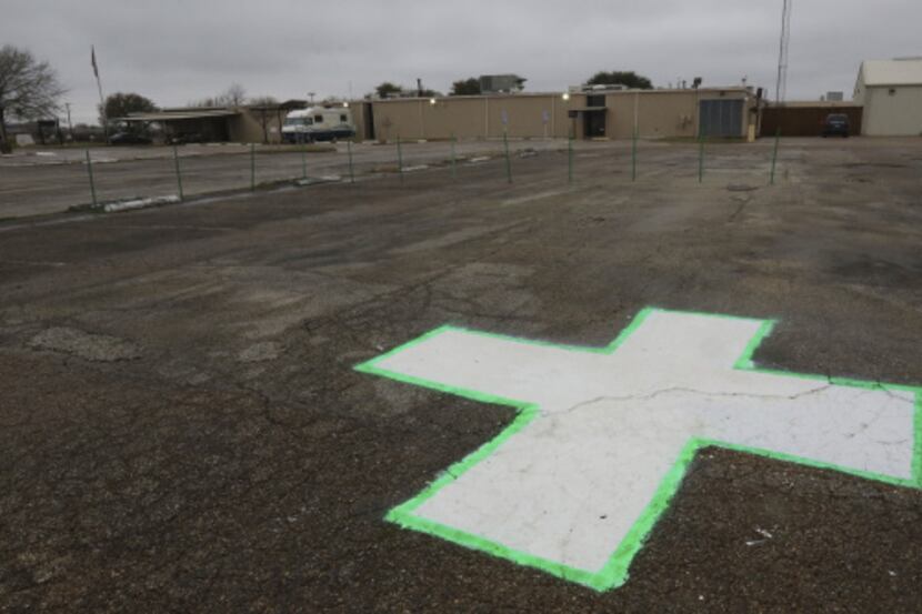 The helipad and parking lot are empty at  the closed Renaissance Hospital in Terrell, and...
