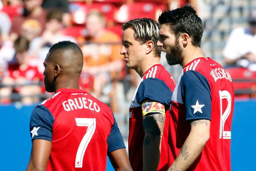 FC Dallas co-captain Reto Ziegler (3), center, is pictured with teammates Carlos Gruezo(7)...