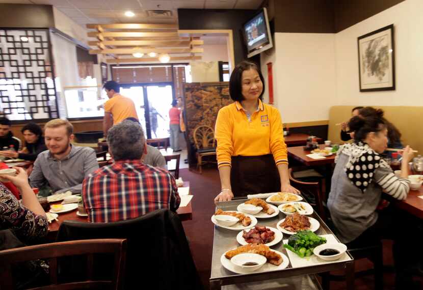 Ling He serves guests at J.S. Chen's Dim Sum and BBQ in Plano. 