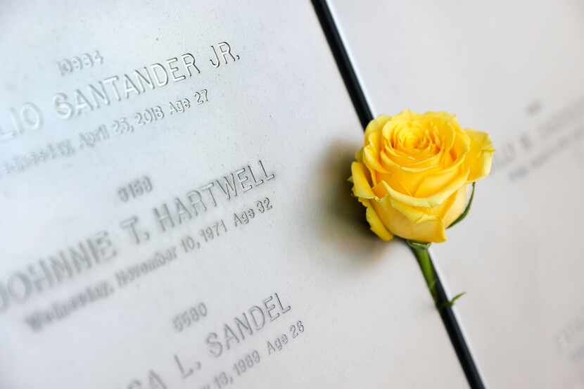 Dallas Police officer Rogelio Santander Jr. was remembered with a yellow rose during the...
