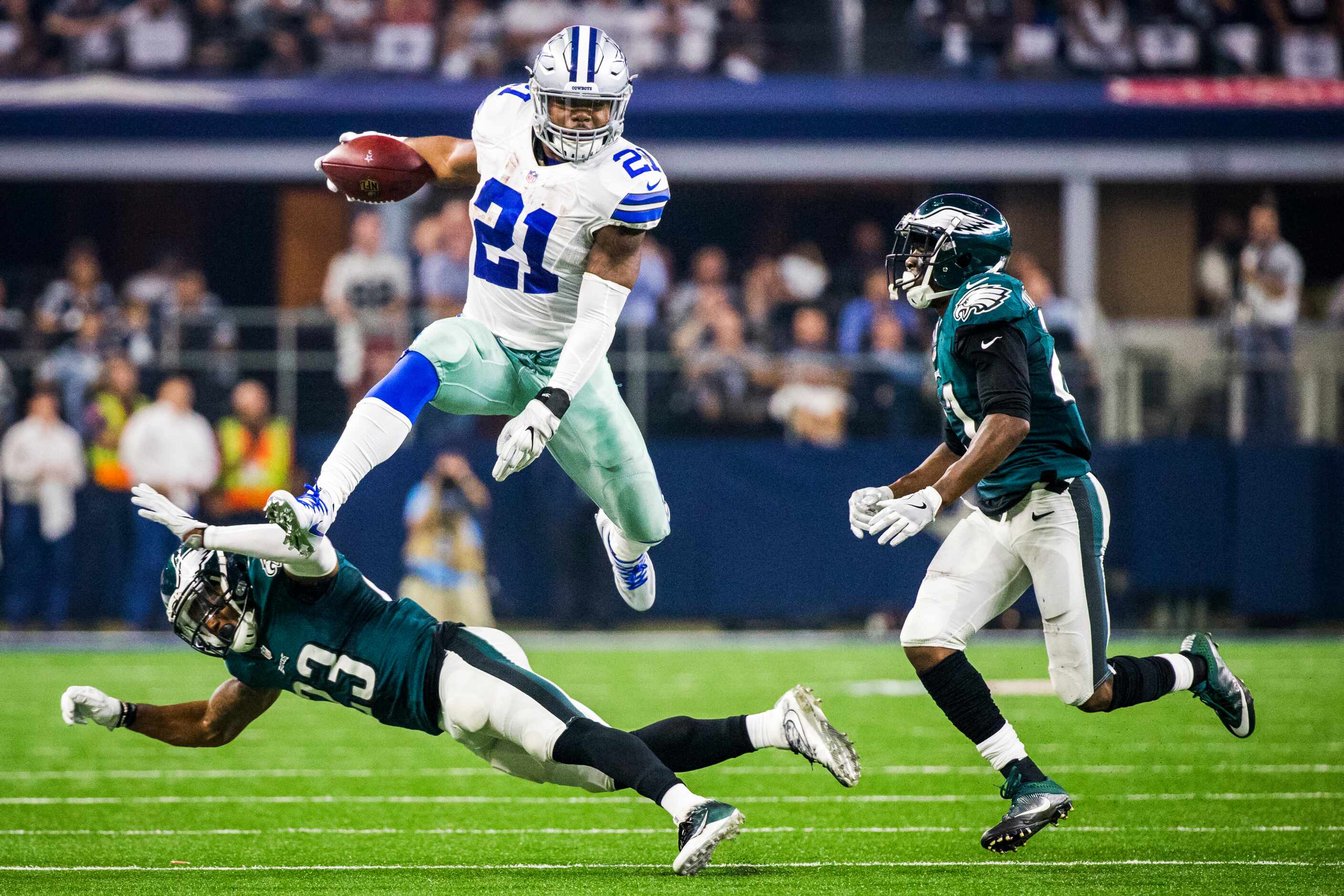Dallas Cowboys running back Ezekiel Elliott (21) hurdles Philadelphia Eagles free safety...