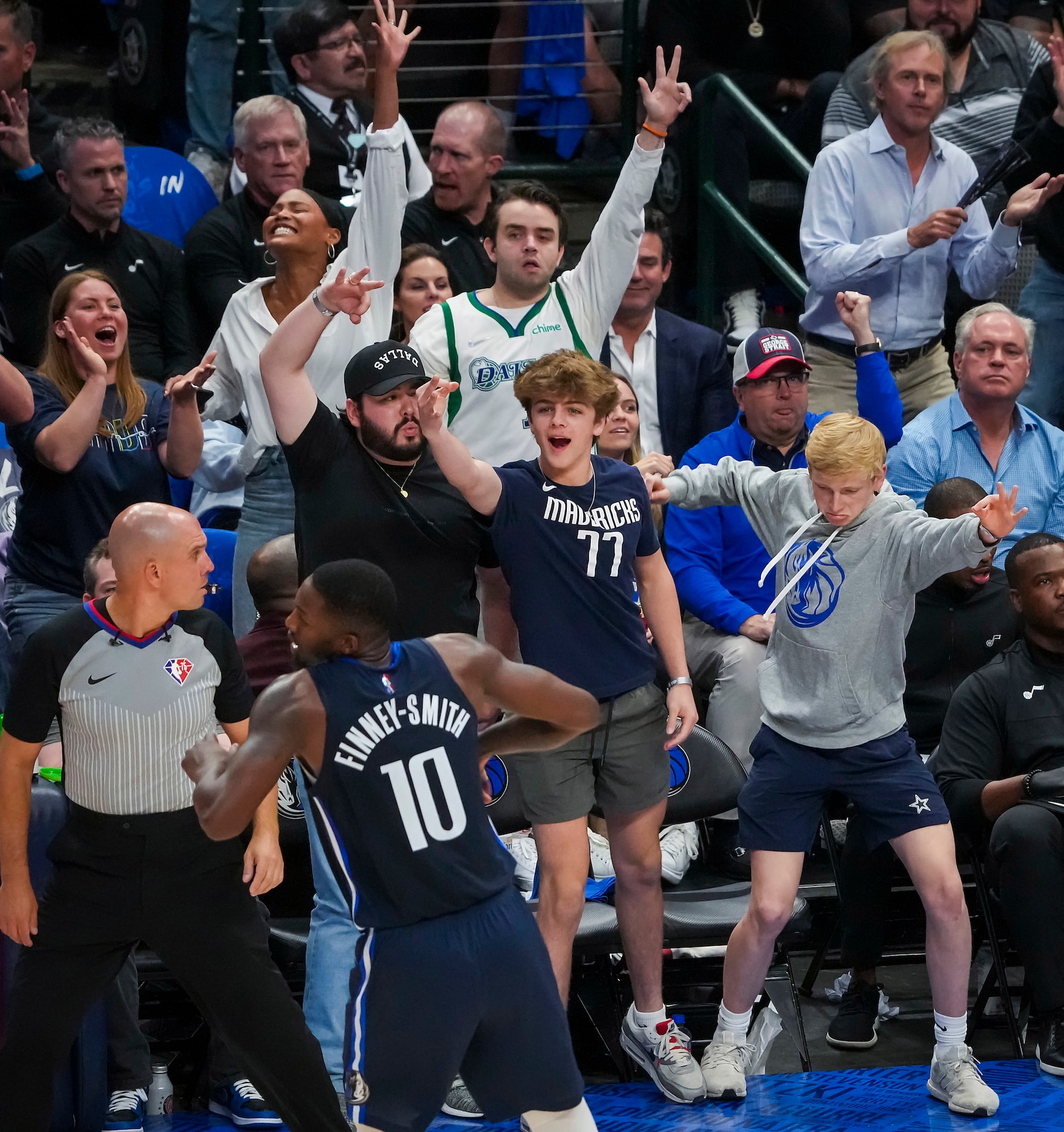 Dallas Mavericks fans cheer a 3-pointer by forward Dorian Finney-Smith (10) during the first...