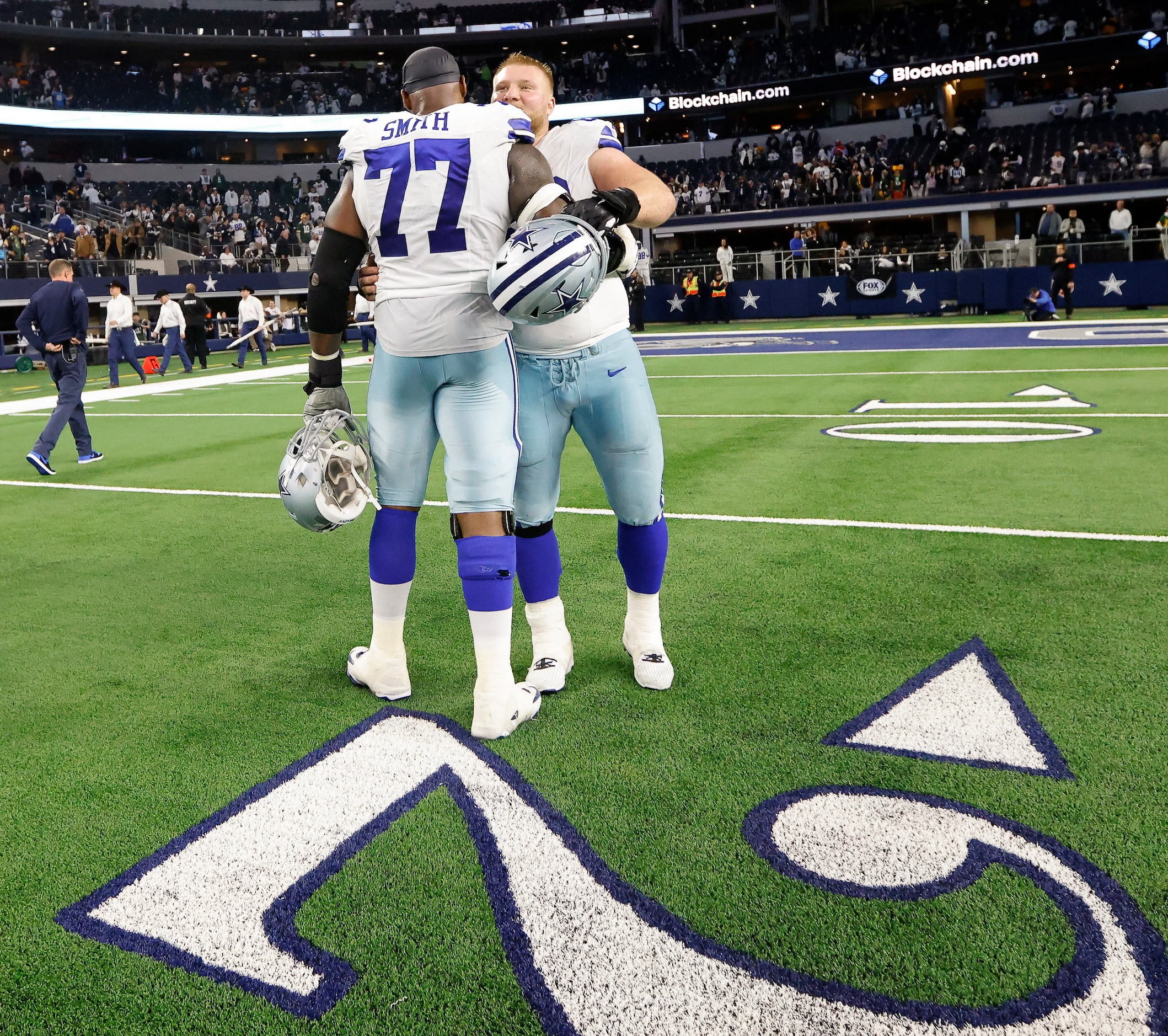 Dallas Cowboys center Tyler Biadasz (63) hugs offensive tackle Tyron Smith (77) following...