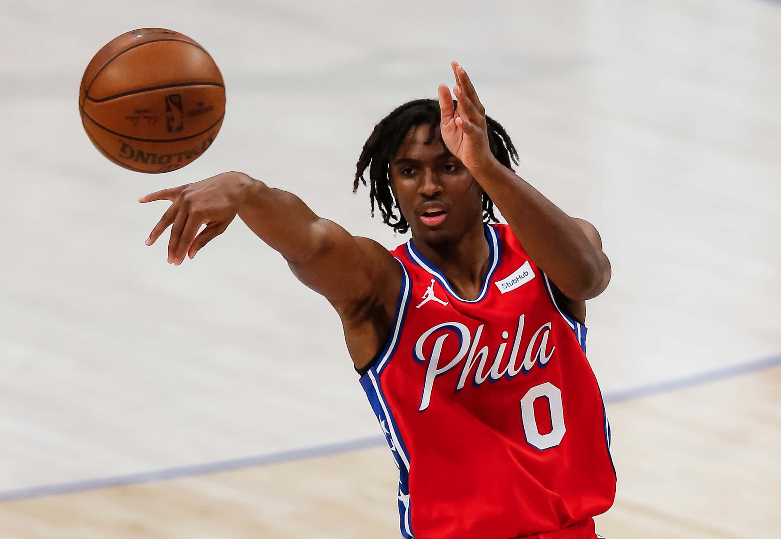 Philadelphia 76ers guard Tyrese Maxey (0) passes during the second half of an NBA basketball...