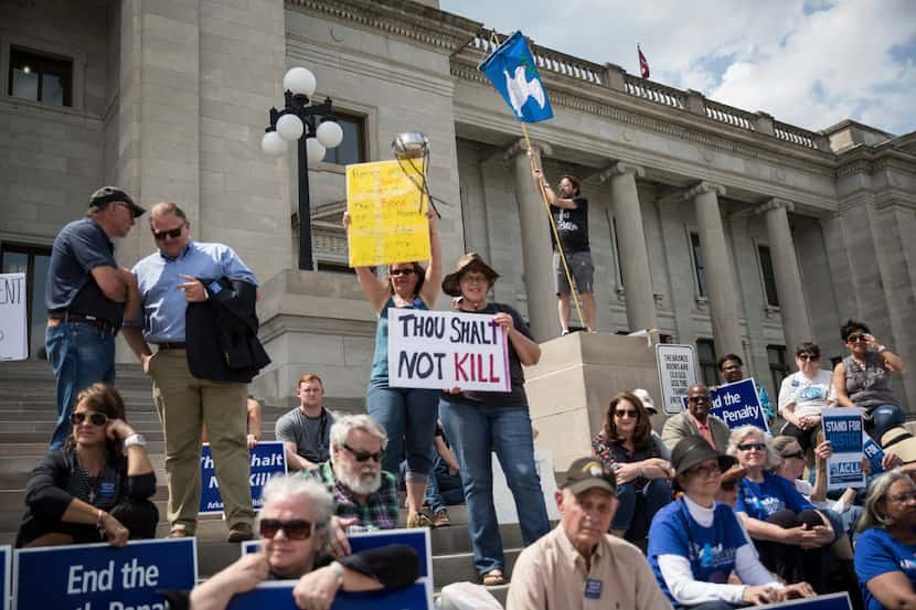 Demonstrators gather in front of the Arkansas State Capitol to protest the death penalty.