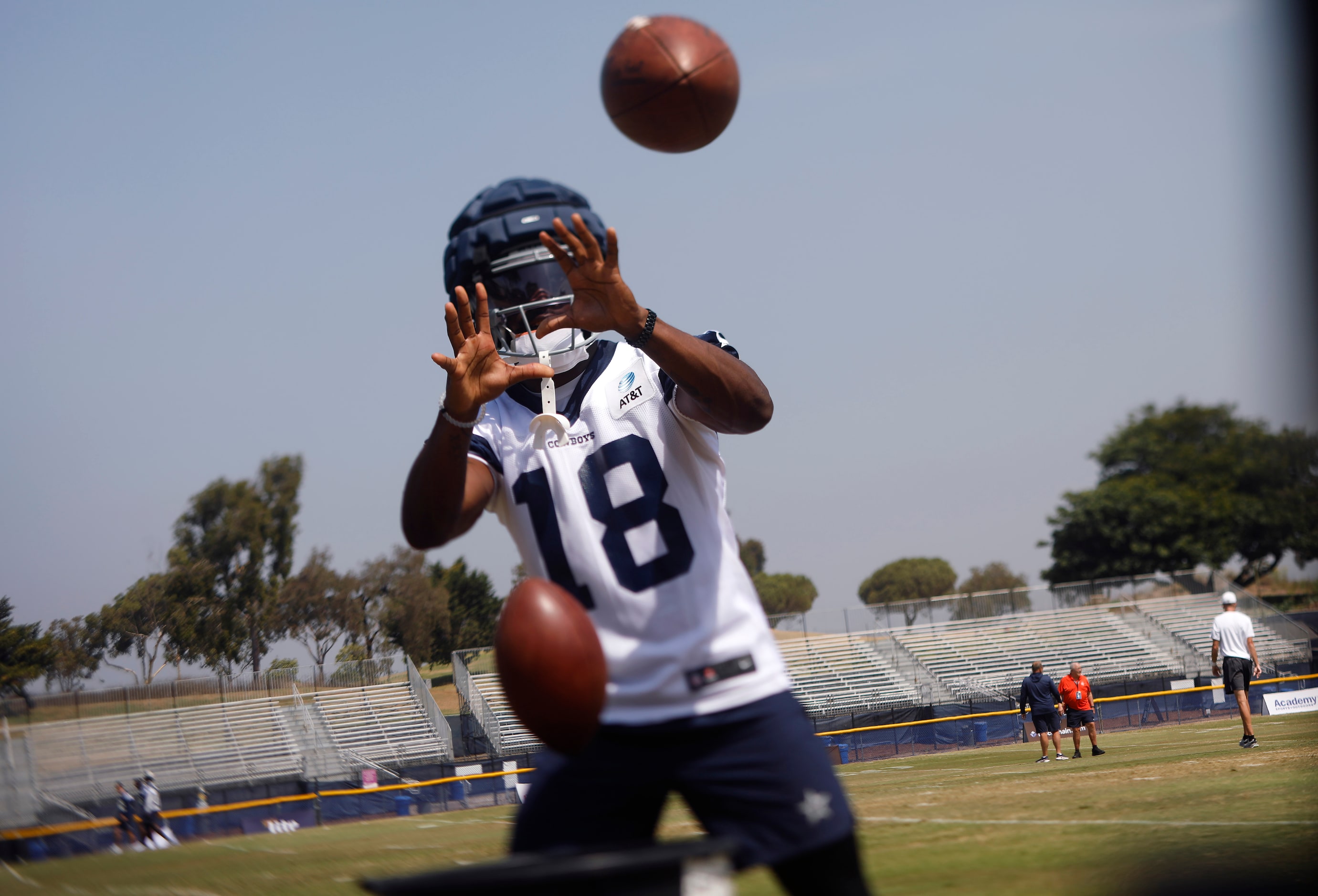 Dallas Cowboys wide receiver Ryan Floumoy (18) catches passes off the throwing machine...