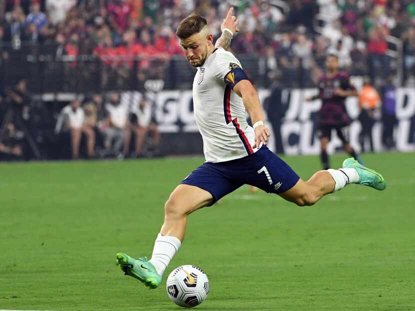 United States forward Paul Arriola (7) kicks the ball against Mexico during the first half...