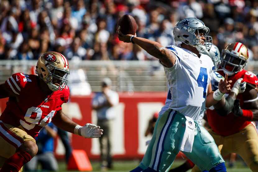 Dallas Cowboys quarterback Dak Prescott (4) throws a pass under pressure from San Francisco...