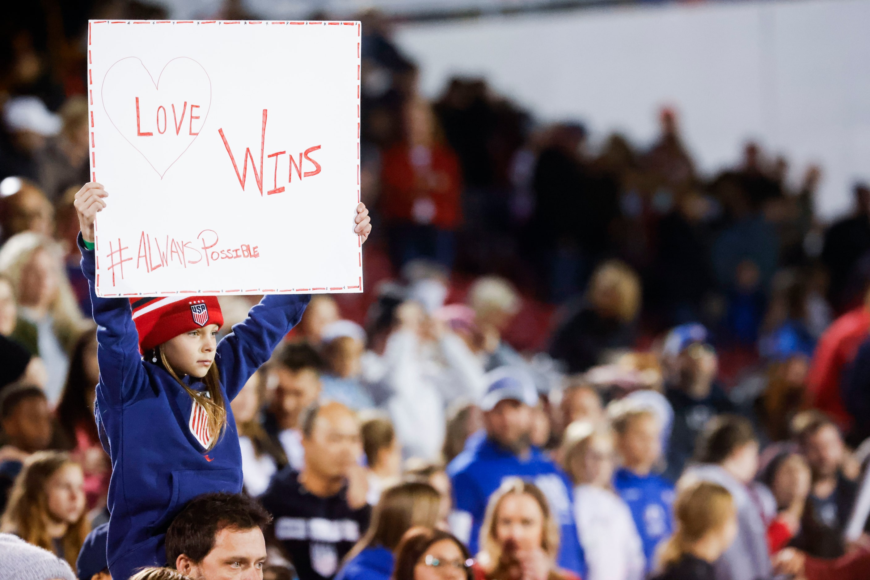 A young fan holds a sign ahead of the first half of a soccer game between United States and...