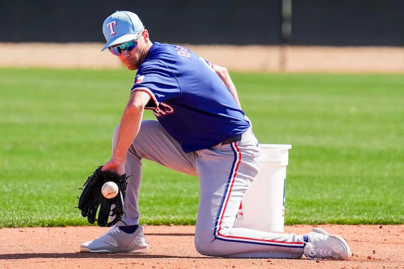 Texas Rangers infielder Matt Duffy participates in a fielding drill during a spring training...