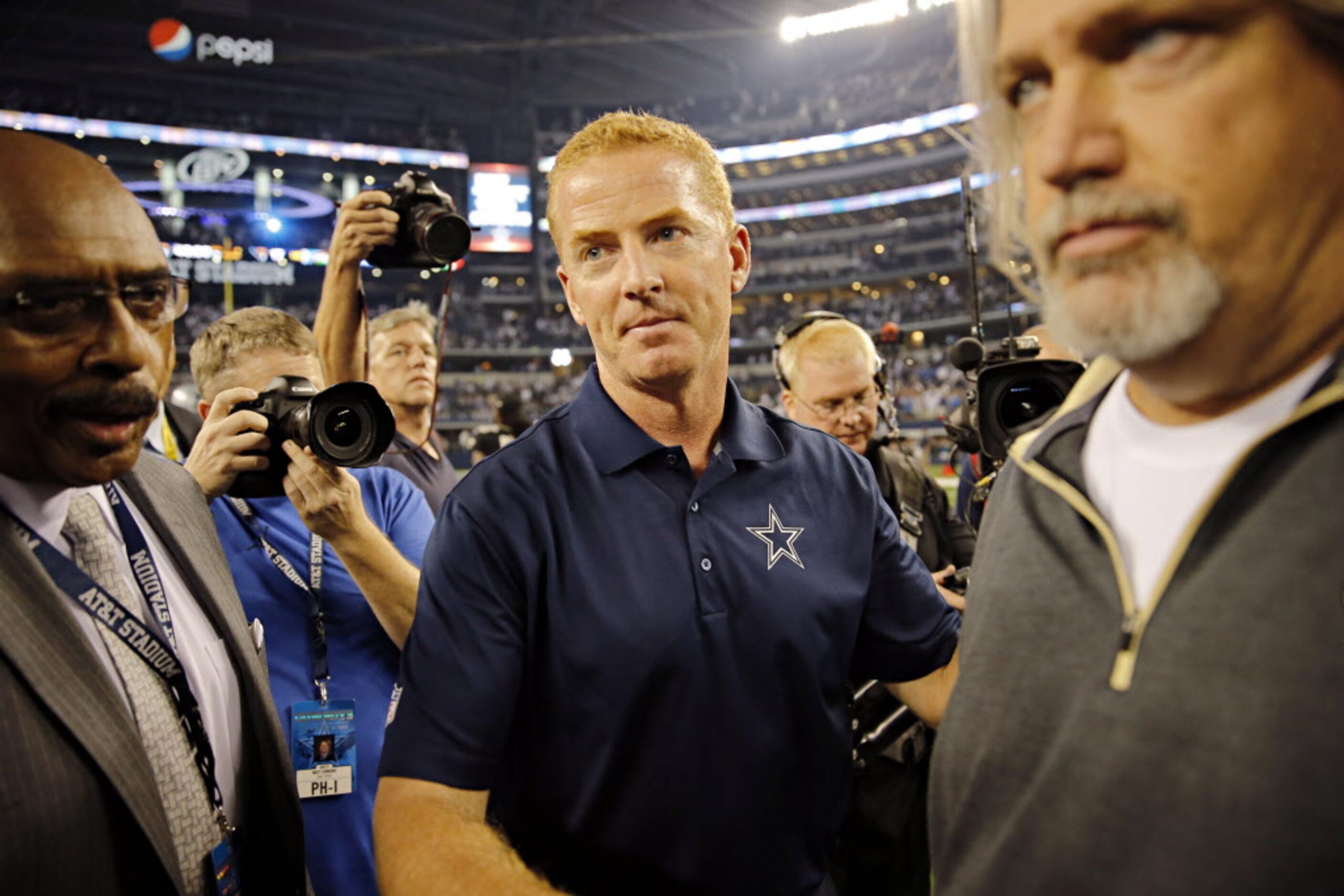 Dallas Cowboys head coach Jason Garrett (left) hugs New Orleans Saints defensive coordinator...