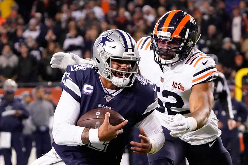 Dallas Cowboys quarterback Dak Prescott (4) is chased down by Chicago Bears outside...