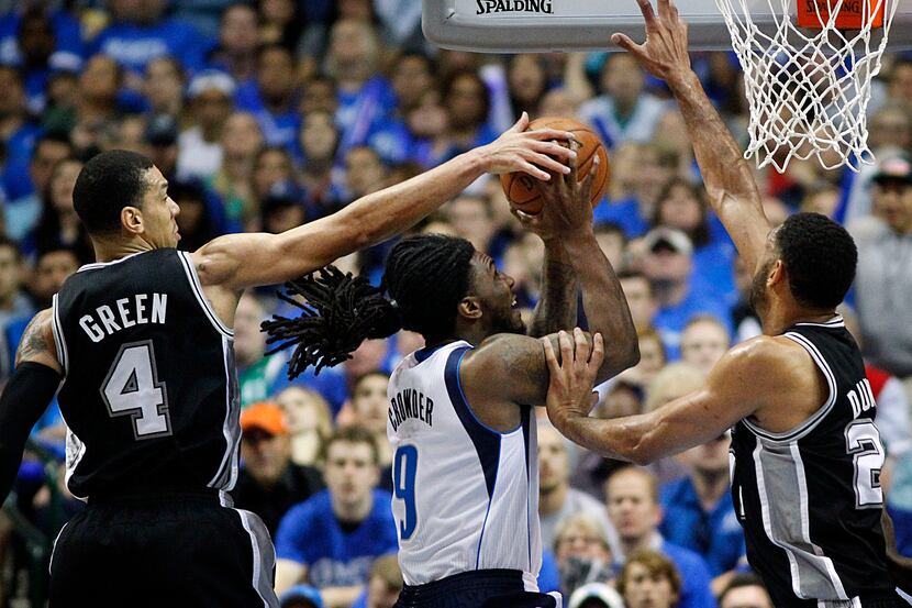 Dallas Mavericks forward Jae Crowder (9) drives hard to the hoop past San Antonio Spurs...