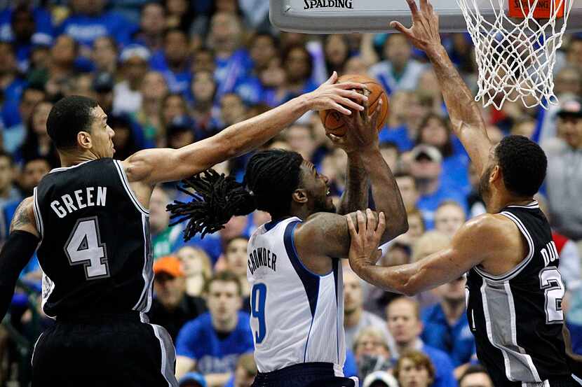 Dallas Mavericks forward Jae Crowder (9) drives hard to the hoop past San Antonio Spurs...