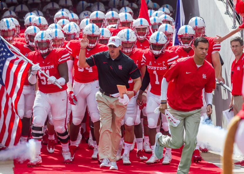 File photo:  Houston Cougars head coach Tom Herman leads the team onto the field during a...