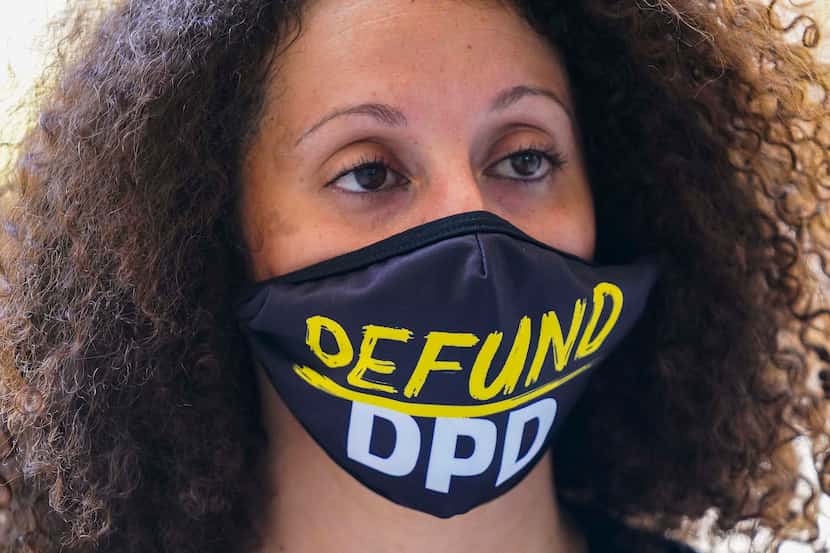 Sara Mokuria of Mothers Against Police Brutality wears a face mask reading ÔDefund DPDÕ...