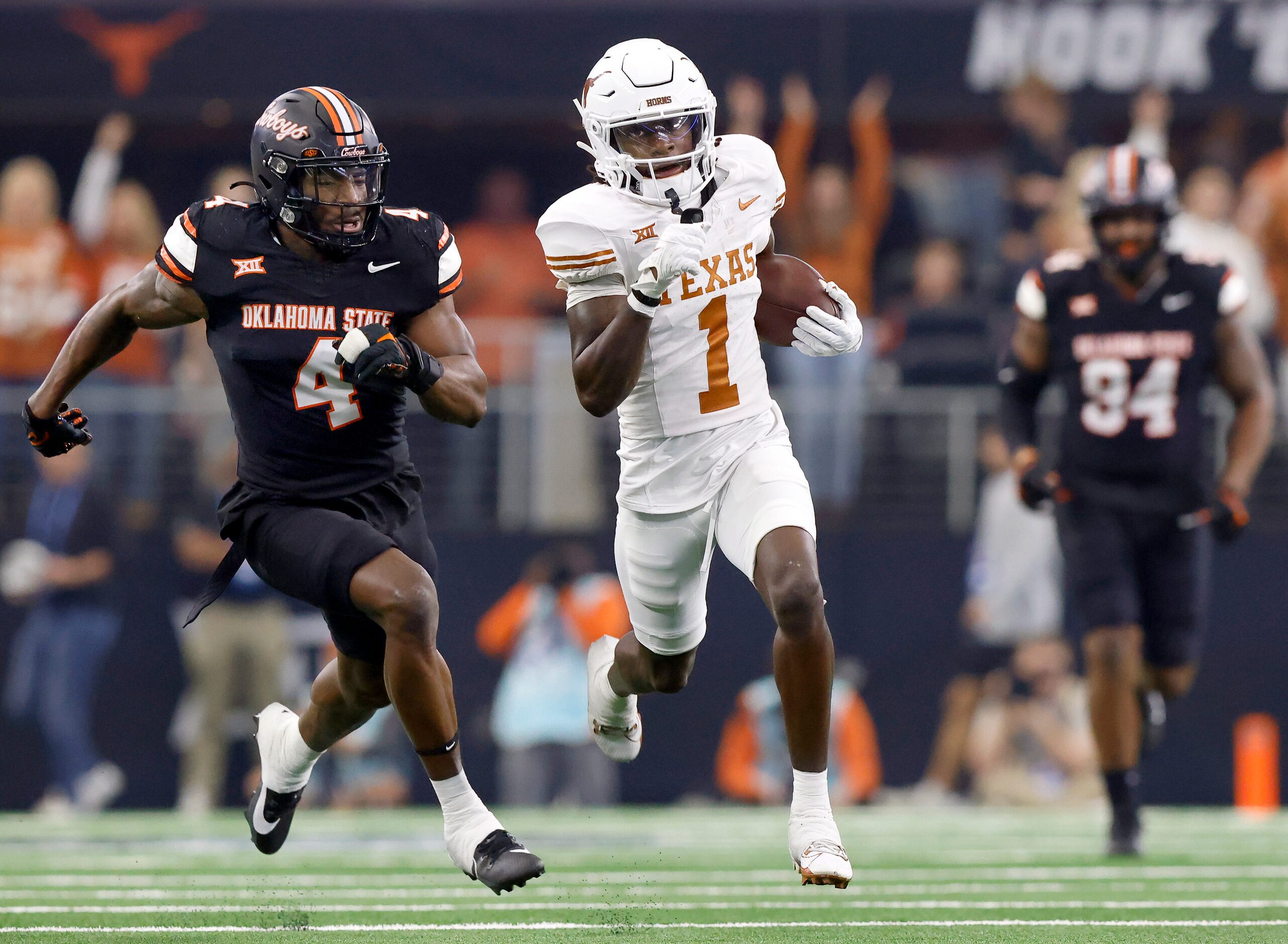 Texas Longhorns wide receiver Xavier Worthy (1) breaks away from Oklahoma State Cowboys...