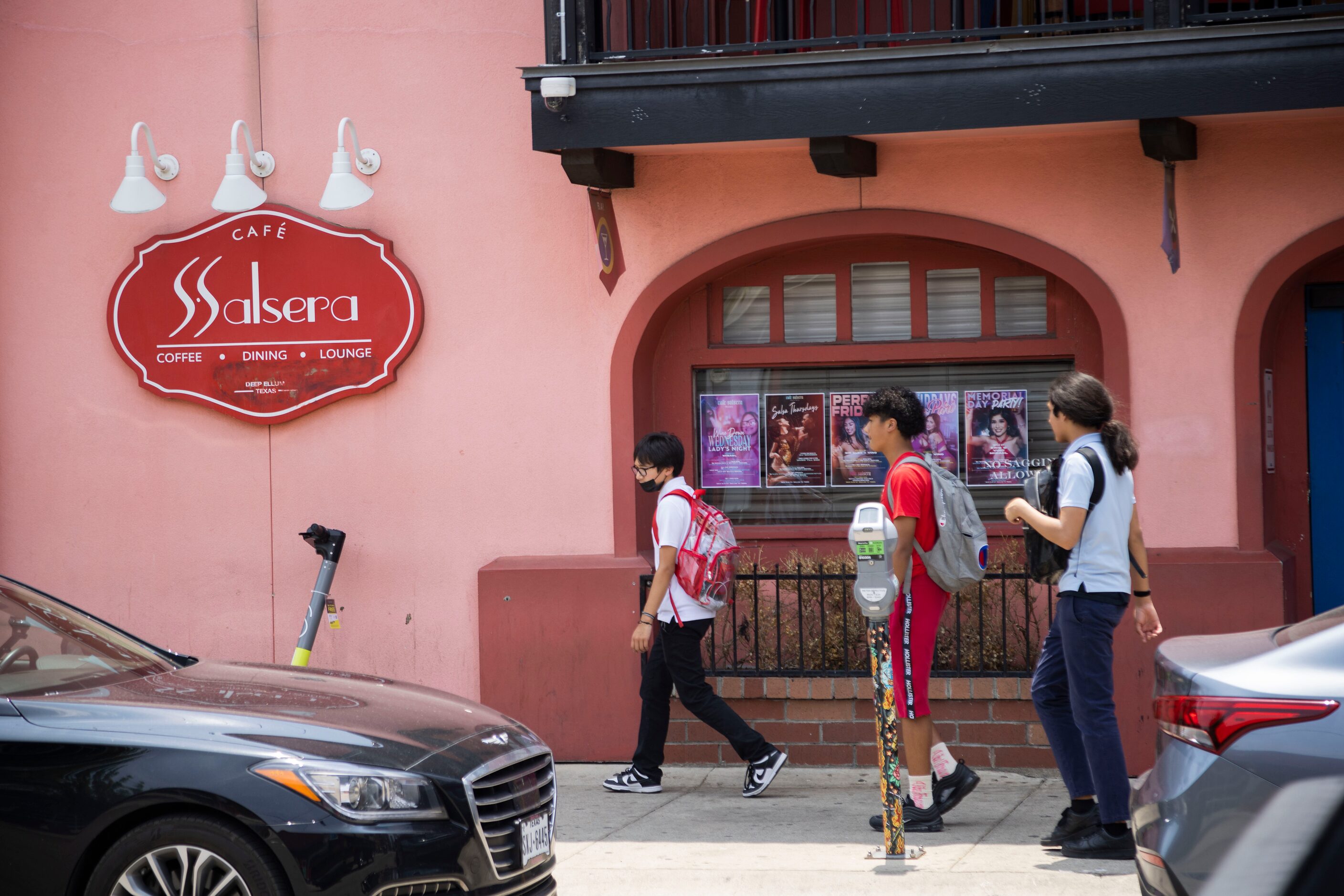 Students from Uplift Luna Preparatory School walk by Cafe Salsera in the Deep Ellum district...