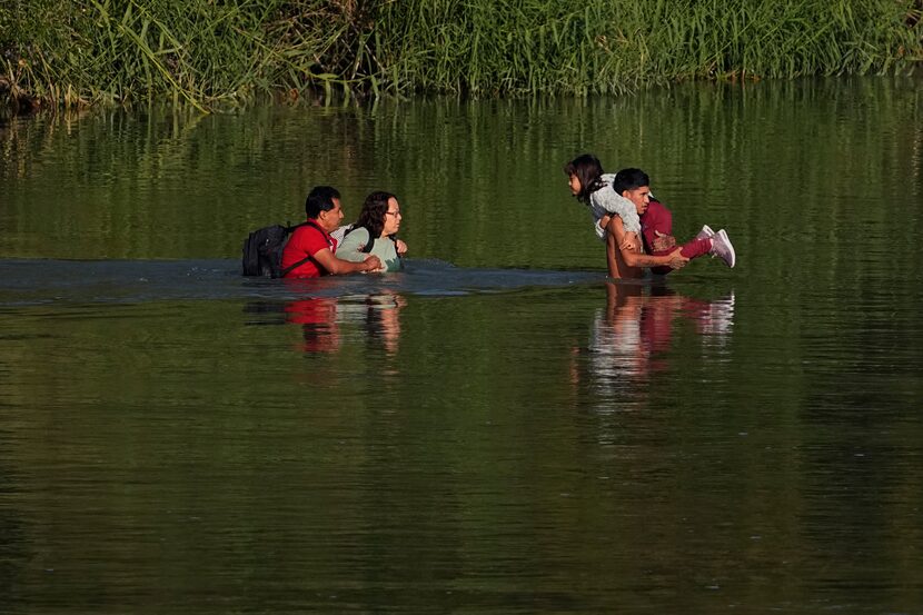 Migrants cross the Rio Grande and entered the U.S. from Mexico, Thursday, Oct. 19, 2023, in...