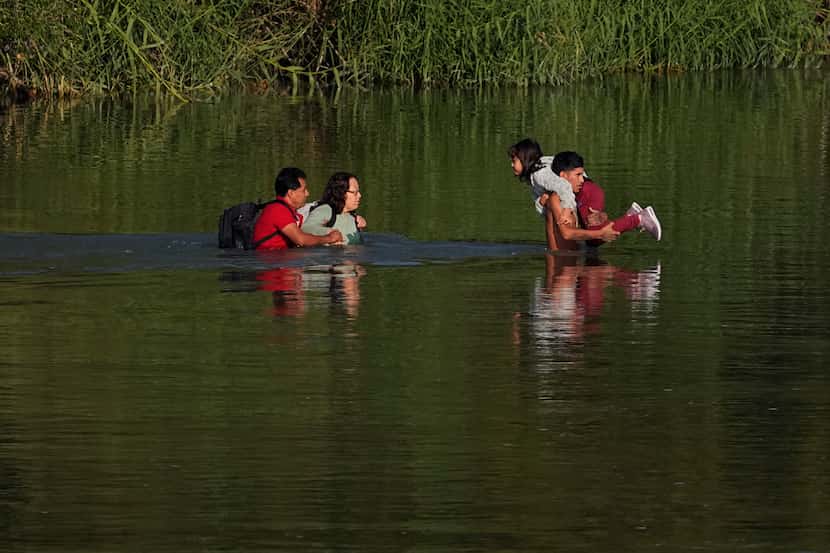 Migrants cross the Rio Grande and entered the U.S. from Mexico, Thursday, Oct. 19, 2023, in...