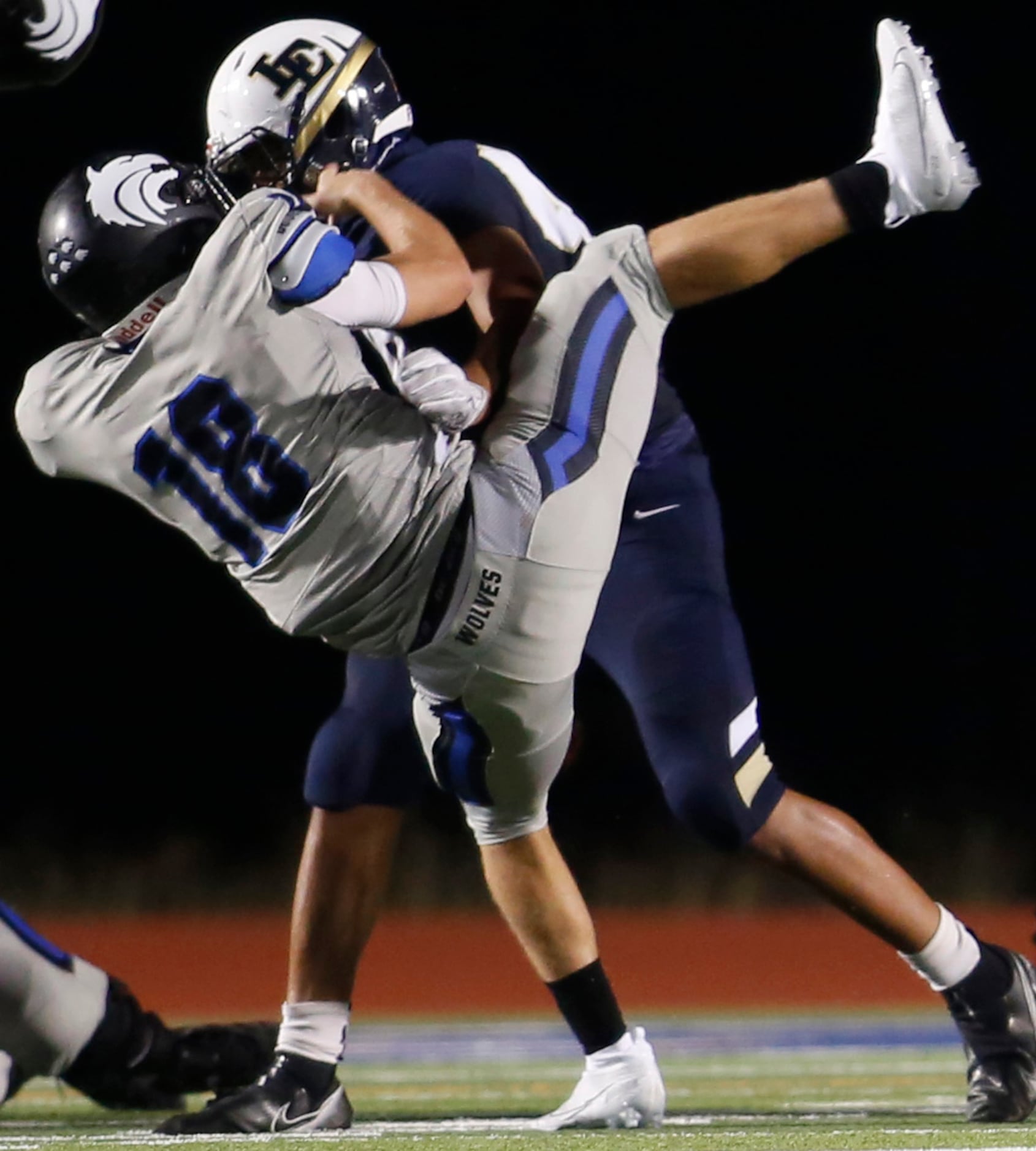 Plano West quarterback Greg Draughn (18) became the recipient of a monster hit from Little...