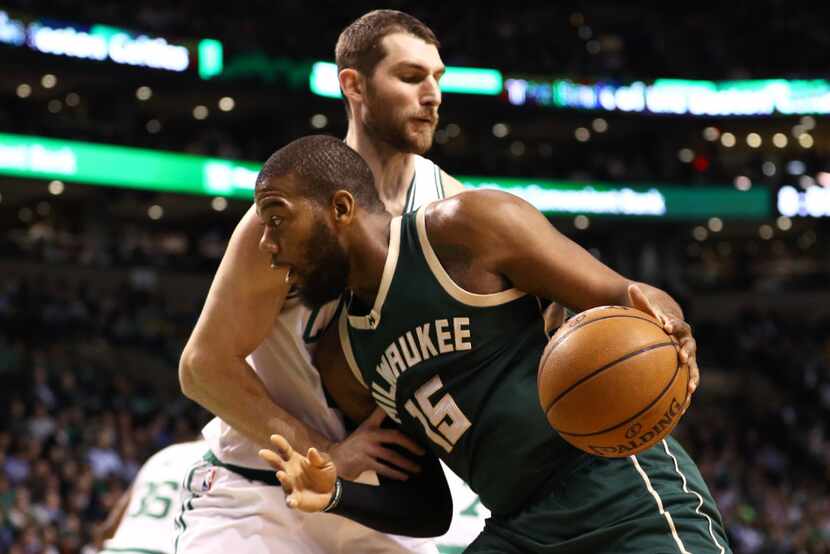 BOSTON, MA - MARCH 29: Greg Monroe #15 of the Milwaukee Bucks drives against Tyler Zeller...