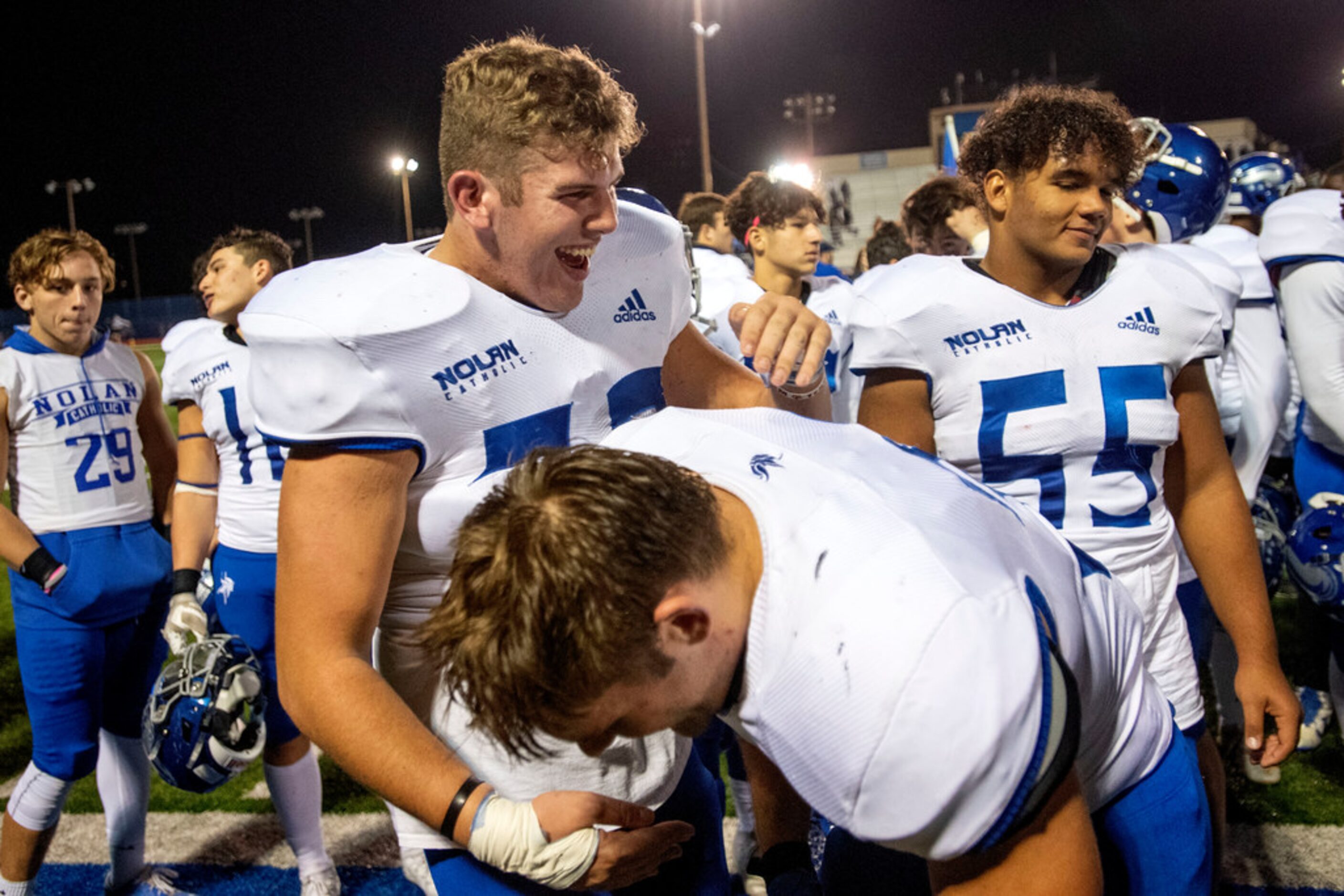 Fort Worth Nolan senior offensive lineman Sean Migliaccio (73), left, celebrates with senior...