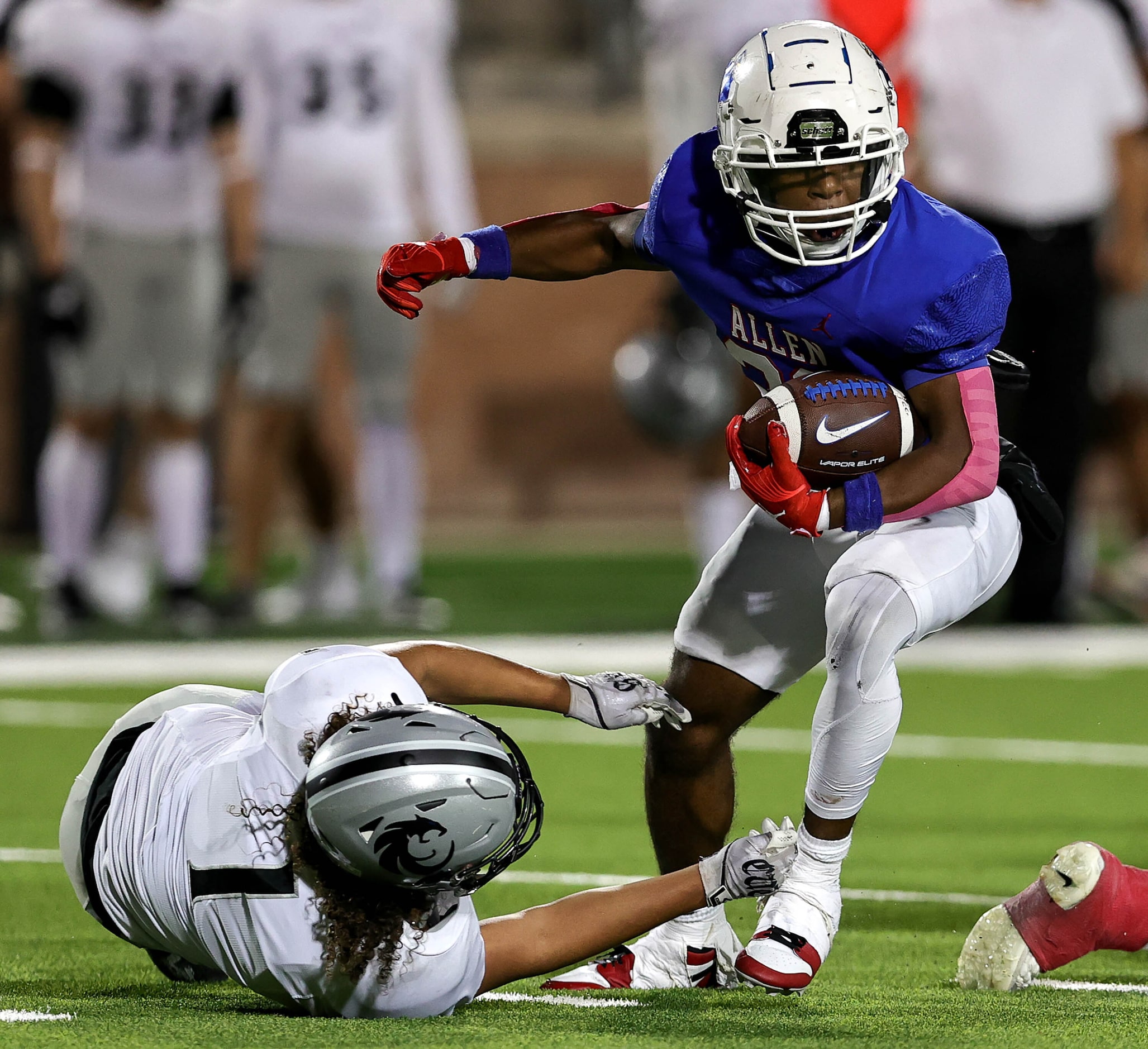 Allen running back Micah Ellis (23) tries to slip past Denton Guyer defensive back Kaedyn...