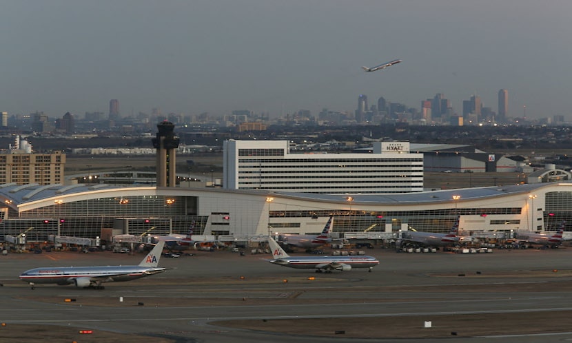 DFW International Airport, pictured on January 07, 2014, with the Dallas skyline in the...