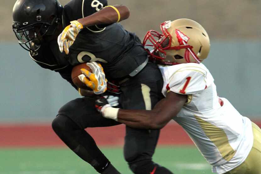 South Oak Cliff receiver Devin McCullough (8) tacks on extra yards following a reception as...
