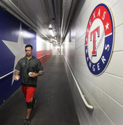 Texas Rangers relief pitcher Matt Bush, right, walks down the tunnel to the field at Globe...