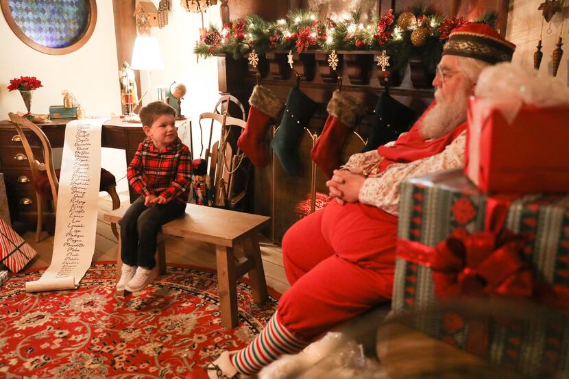 Fox Hoferer, 3, talks with Santa about dinosaurs and his wish list at Santaland in Galleria...