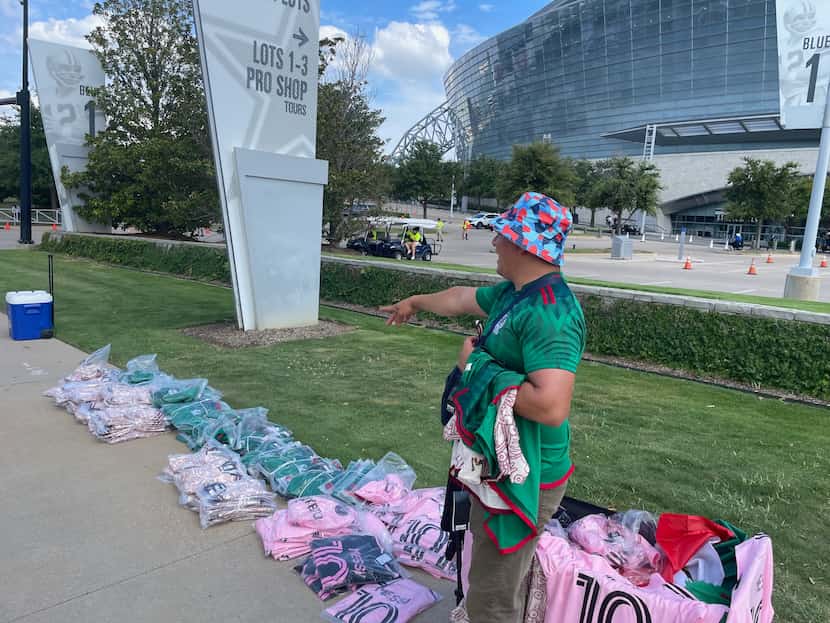 Merchandise vendor Onam Euzada talks with customers outside AT&T Stadium prior to the...