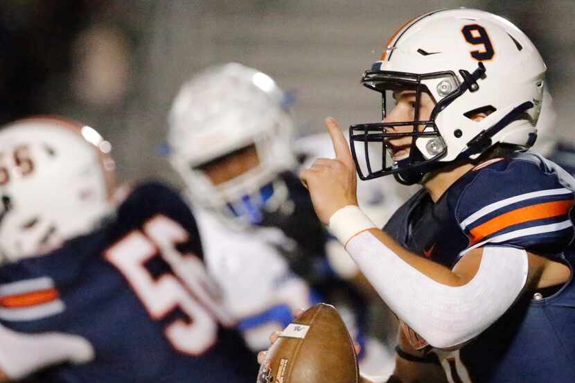 Wakeland High School quarterback Brennan Myer (9) signals his receiver on the run during the...